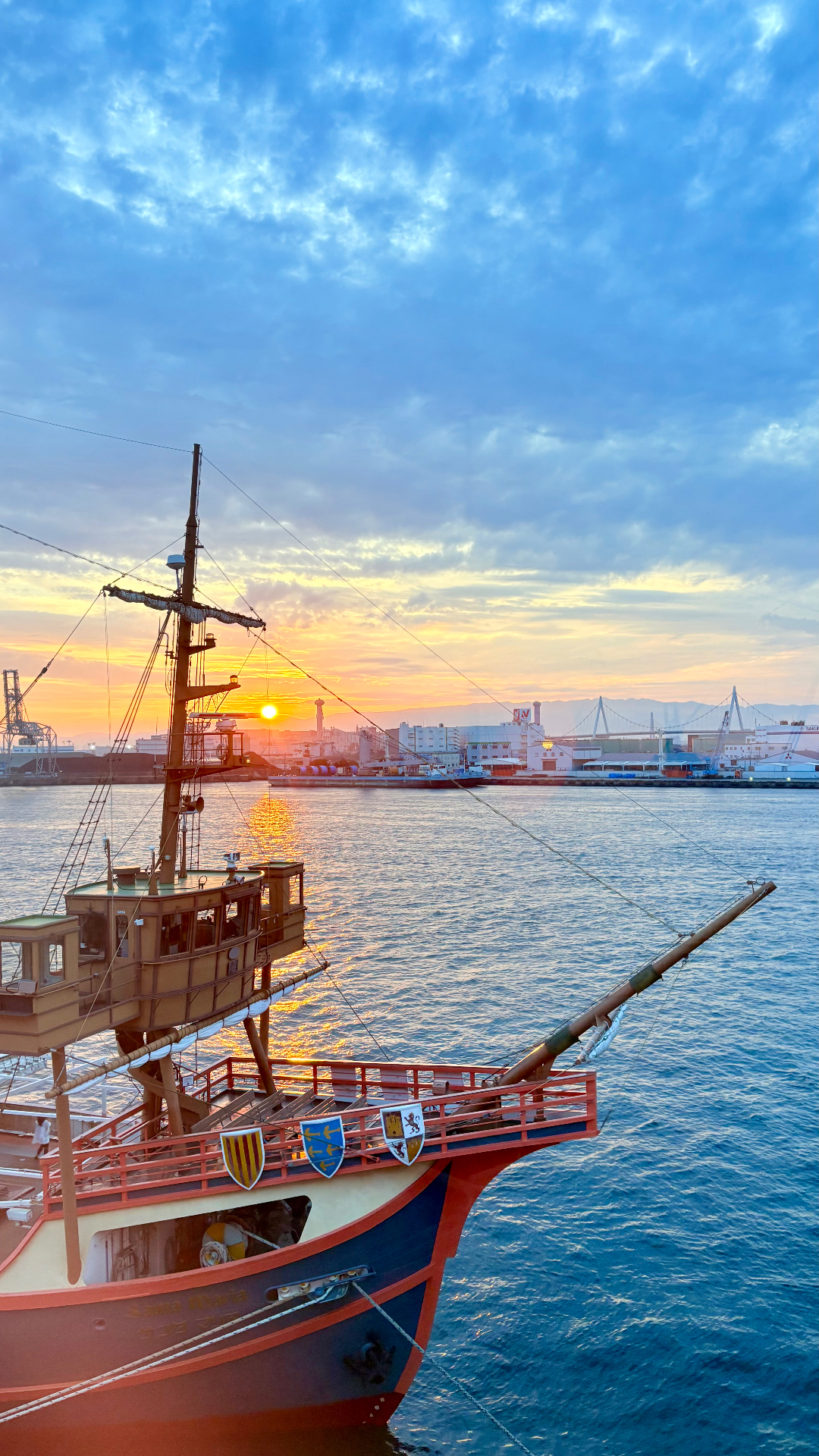 Tall ship moored in a harbour at sunrise